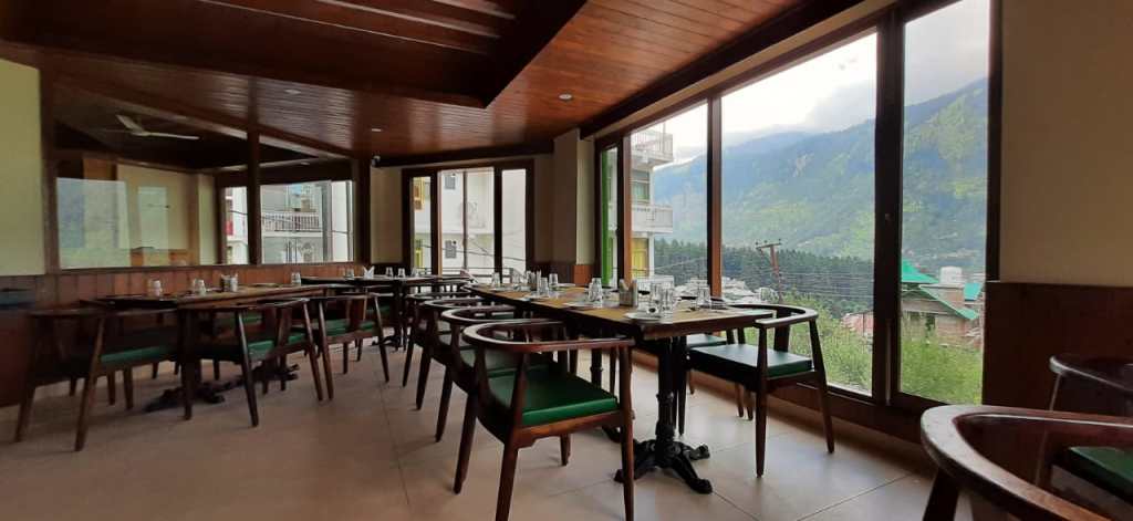 Xanadu by 1522, a bar in Manali, featuring Kernig Krafts' exquisite bar furniture. The image showcases a stunning bar area with sleek and modern design elements. The bar counter, crafted by Kernig Krafts, is adorned with polished wood and metal accents, creating a sophisticated and luxurious feel. The bar stools, upholstered in premium leather, provide comfortable seating for patrons. The overall ambiance is enhanced by soft lighting, highlighting the elegance of the furniture. This bar exudes a chic and upscale atmosphere, perfect for enjoying cocktails and socializing in the heart of Manali.