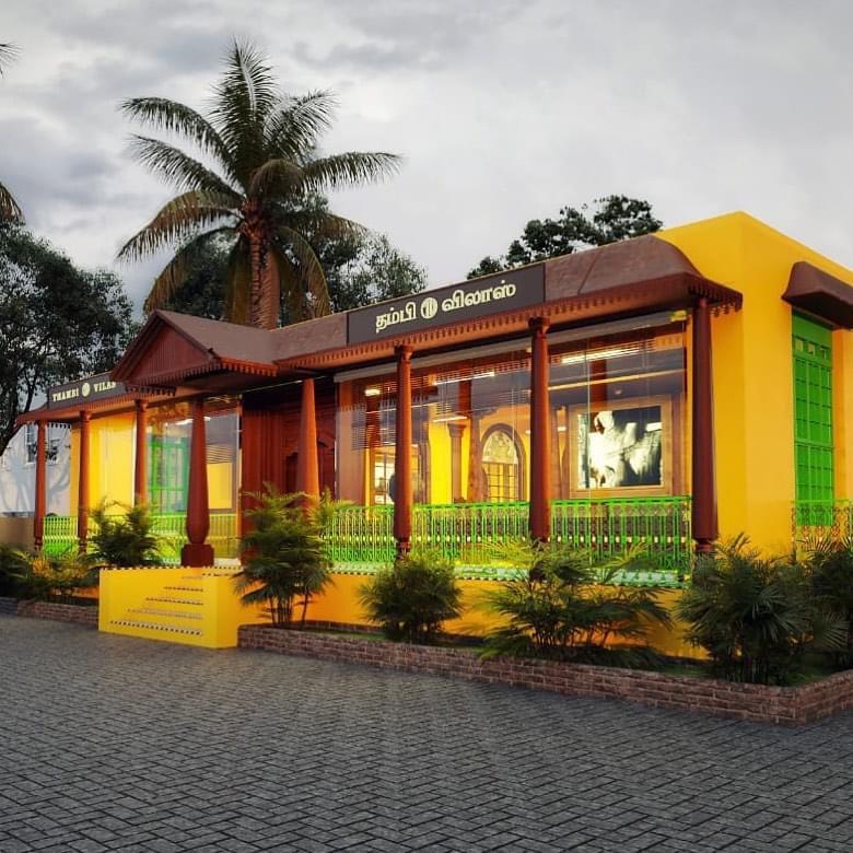 A beautifully crafted wooden dining table and chairs, designed specifically for Thanjai Thambivilas, a traditional South Indian restaurant in Thanjavur. The bespoke furniture, created by Kernig Kraftsm, showcases intricate carvings and ornate details that perfectly complement the restaurant's traditional theme. The table features a rich, dark wood finish, while the chairs are upholstered in vibrant, handwoven fabrics, adding a touch of elegance and cultural charm to the dining area.
