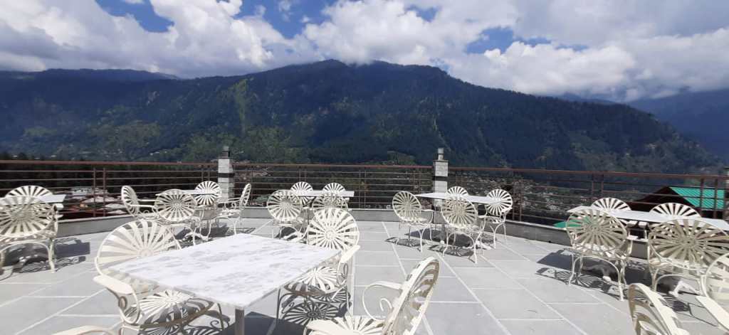 Exquisite bar furniture by Kernig Krafts showcased at Xanadu by 1522 in Manali. The image reveals a stylish and sophisticated bar area adorned with carefully crafted furniture. The bar counter stands out with its sleek design, featuring a polished marble top and a row of high-quality bar stools. Surrounding the bar, luxurious lounge chairs and plush couches create a comfortable and inviting seating arrangement. The furniture's attention to detail and exquisite craftsmanship is evident, exuding an aura of elegance and refinement. The overall ambiance reflects the perfect blend of modern aesthetics and a warm, welcoming atmosphere, offering a delightful experience for patrons at Xanadu by 1522 in Manali.