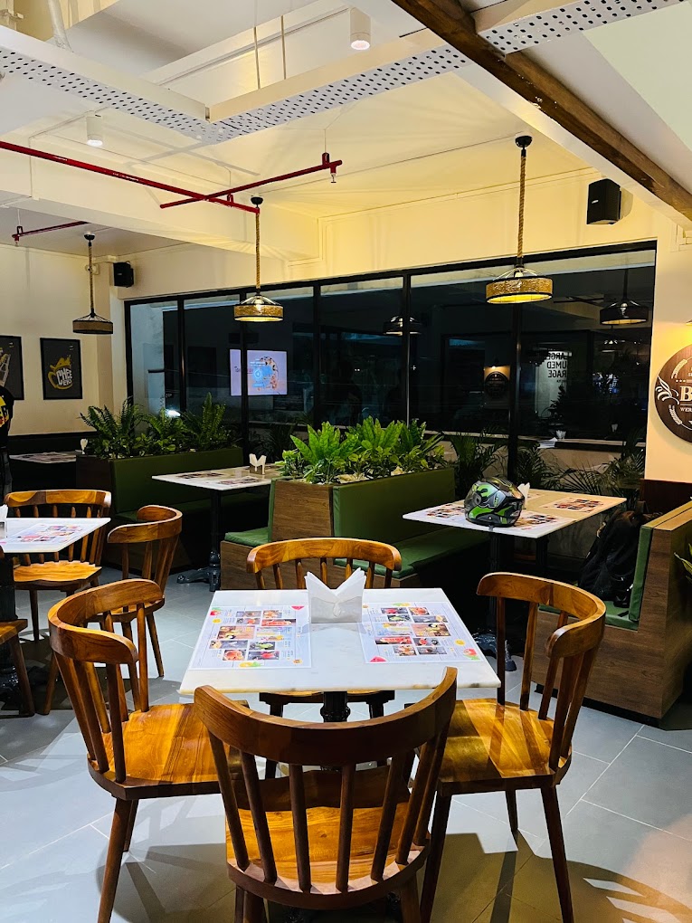 Discover the allure of meticulously crafted wooden & metal furniture at Kernig Kraft, where small-scale masterpieces seamlessly blend durability and comfort, elevating your space with a touch of elegance and artistry at Beer Cafe, Guwahati by Kernig Krafts, Jodhpur