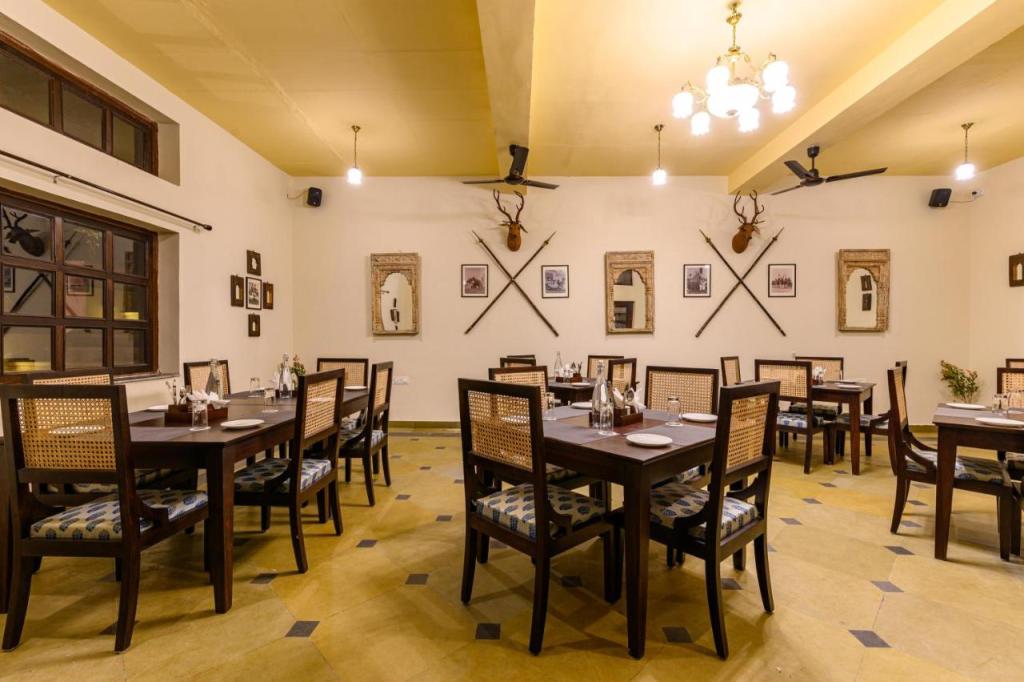 A centerpiece dining table, resplendent with a rich wooden grain, stands as a testament to the brand's craftsmanship. Surrounding it, chairs adorned with intricate ironwork and plush sofas upholstery invite you to indulge in comfort and style.