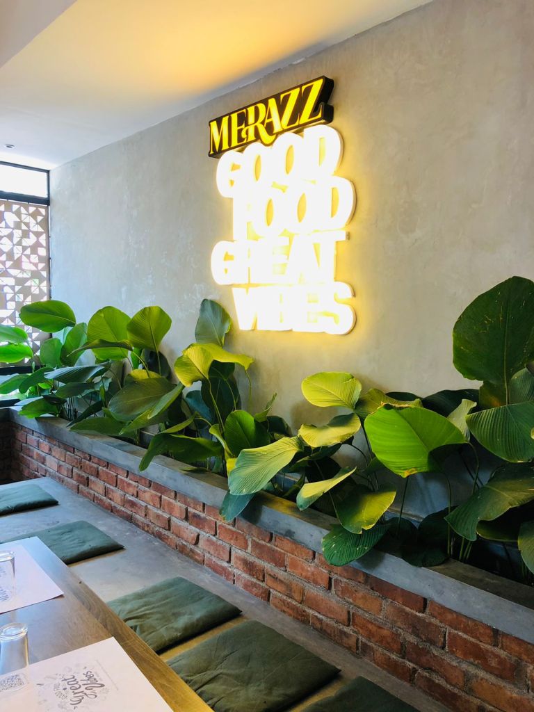 The seamless fusion of wooden top, iron chairs and upholstery creates a harmonious visual feast.