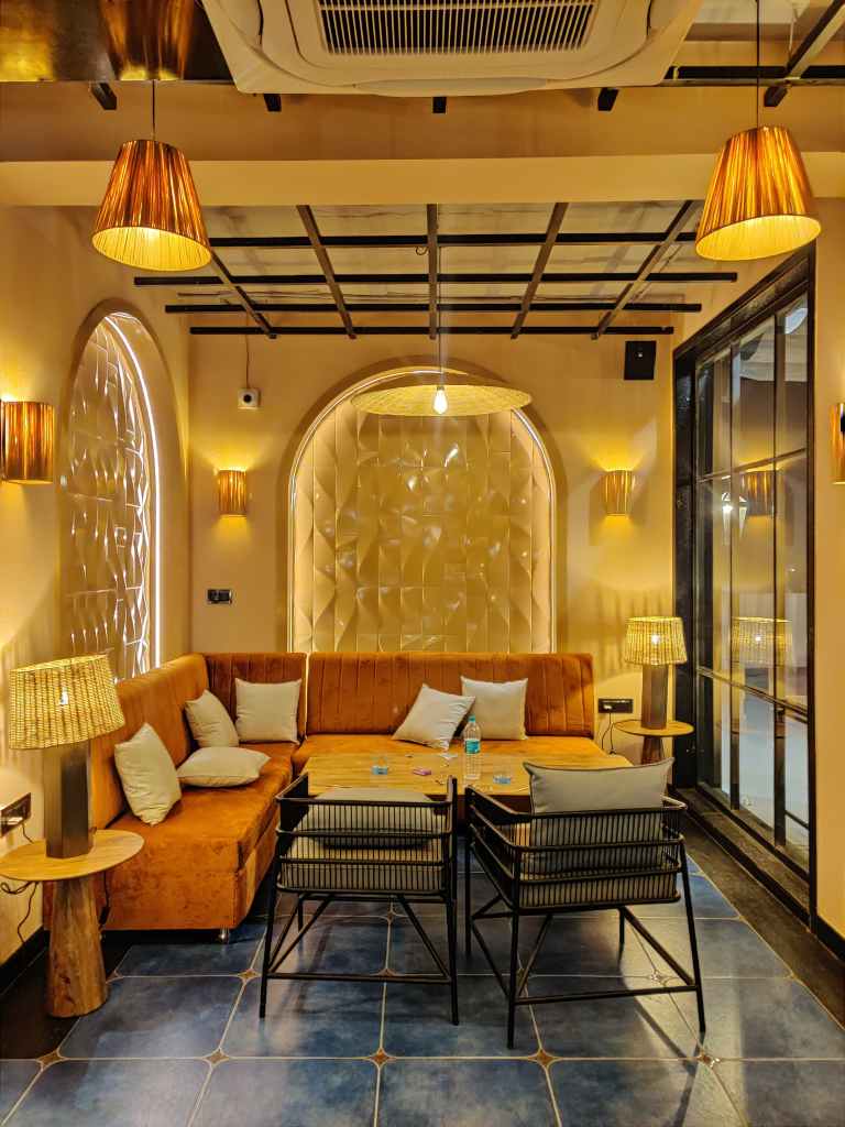 "Elegant L-shape upholstered sofa offering spacious seating for a luxurious lounge experience at House of Arches, Jodhpur."