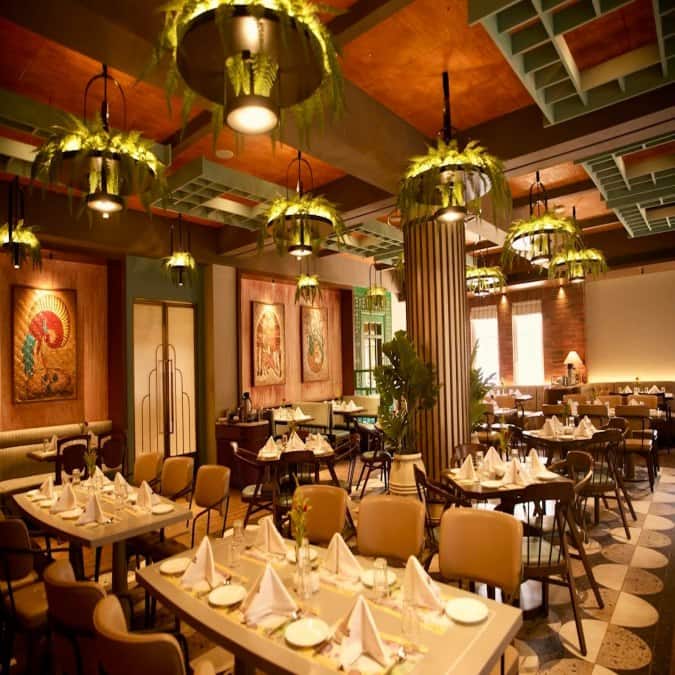 Bar counter setup with upholstered bar chairs and marble detailing.