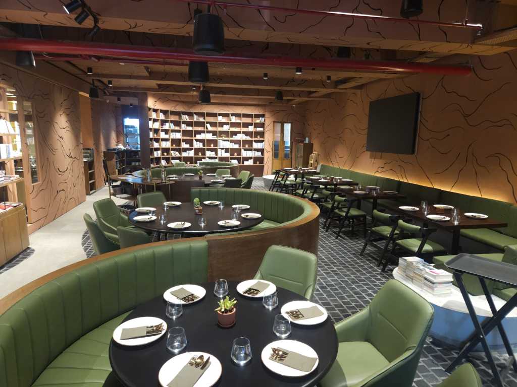 Bar counter setup with upholstered bar chairs and marble detailing.